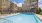 Resort style pool with hammocks, outdoor lounge with TV and outdoor kitchen