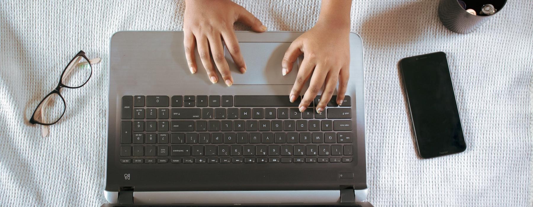 a person typing on a laptop